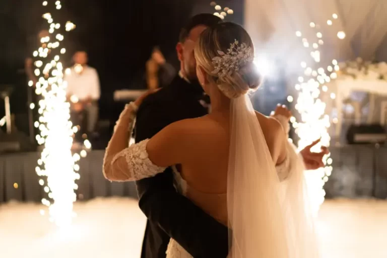 A bride and groom share a first dance, with sparklers lighting up the background as Boston Band provides unforgettable wedding music at their reception.